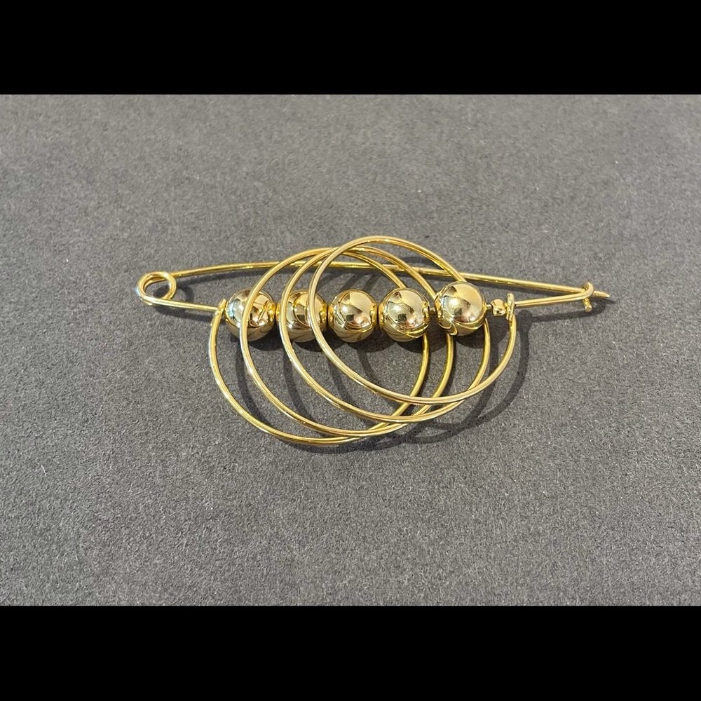 MCM brooch